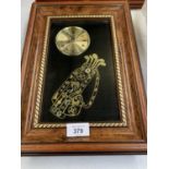 A FRAMED CLOCK WITH A GOLF BAG AND CLUBS DECORATION