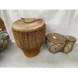 TWO TRIBAL STYLE DRUMS TO INCLUDE A LARGE SINGLE AND A DOUBLE
