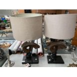 A PAIR OF TABLE LAMPS WITH CURLED HORN DECORATION AND CREAM SHADES