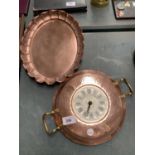A COPPER OVAL TRAY WITH A FLUTED EGDE AND A COPPER PAN STYLE CLOCK WITH ROMAN NUMERAL FACE AND BRASS