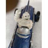 A MICHELIN MAN IN A CAST BLUE RACING CAR 27CM LONG