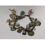 A LADIES STAMPED SILVER CHARM BRACELET WITH SIXTEEN STAMPED SILVER CHARMS