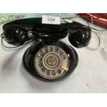 A BLACK VINTAGE STYLE TELEPHONE WITH ROTARY DIAL, WIRE AND SOCKET PLUG