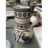 A CREAM STONE JUG WITH A BIRD DESIGN IN BLUE AND A PEWTER LID ENGRAVED KB 2