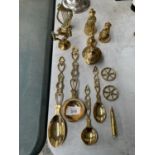 A COLLECTION OF BRASSWARE TO INCLUDE SPOONS, WELSH LADIES, HARP, WHEELS ETC