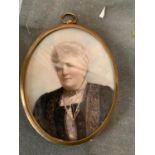 A MINATURE OVAL WATERCOLOUR PORTRAIT OF A LADY