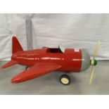 A VINTAGE STYLE TIN PLATE MODEL OF A RED AEROPLANE WITH SINGLE PROPELLER