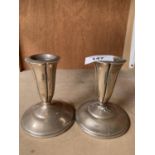 A PAIR OF SILVER CANDLES STICKS (ONE REPAIRED) 11CM HIGH