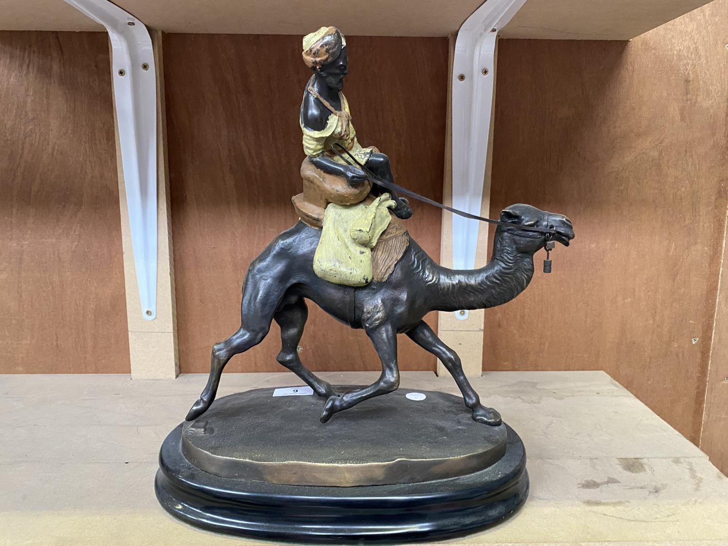 A LARGE BRONZE MODEL OF A CAMEL AND RIDER ON MARBLE BASE