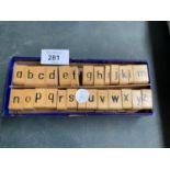 A BOXED COMPLETE SET OF THE ALPHABET WOODEN AND RUBBER STAMPS