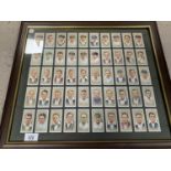 A FRAMED PICTURE CONTAINING FIFTY PLAYERS CIGARETTE CARDS DEPICTING FAMOUS CRICKETERS