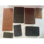 SEVEN VINTAGE WALLETS AND PURSES INCLUDING ONE WITH HALLMARKED BIRMINGHAM SILVER CORNERS