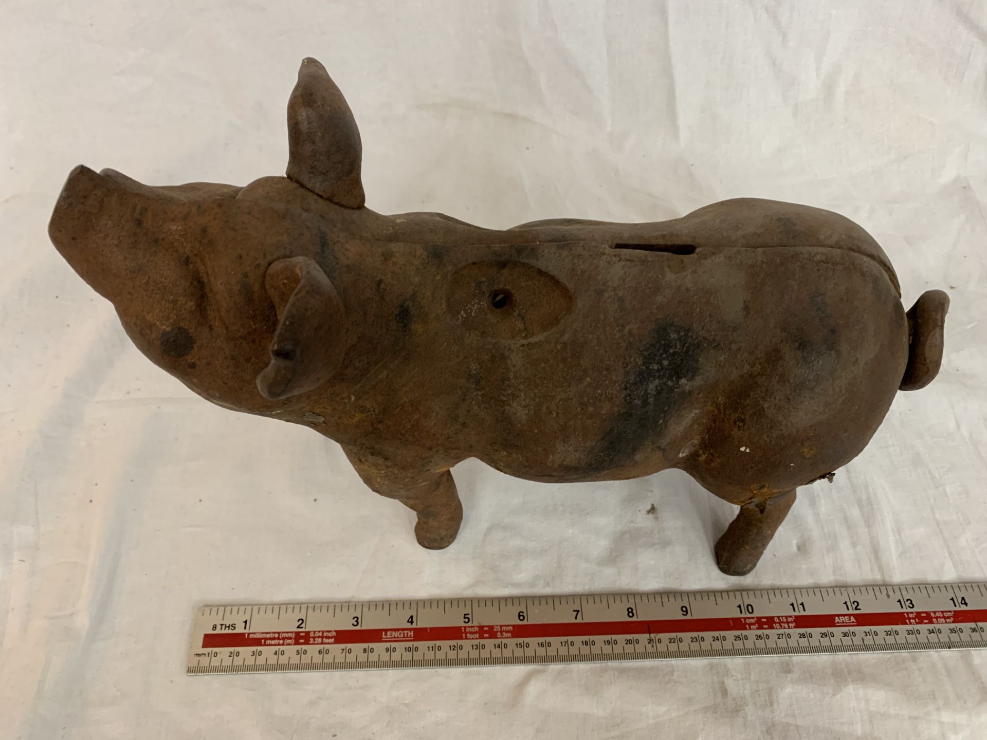 A VINTAGE CAST IRON PIG APPROXIMATELY 14 INCHES LONG