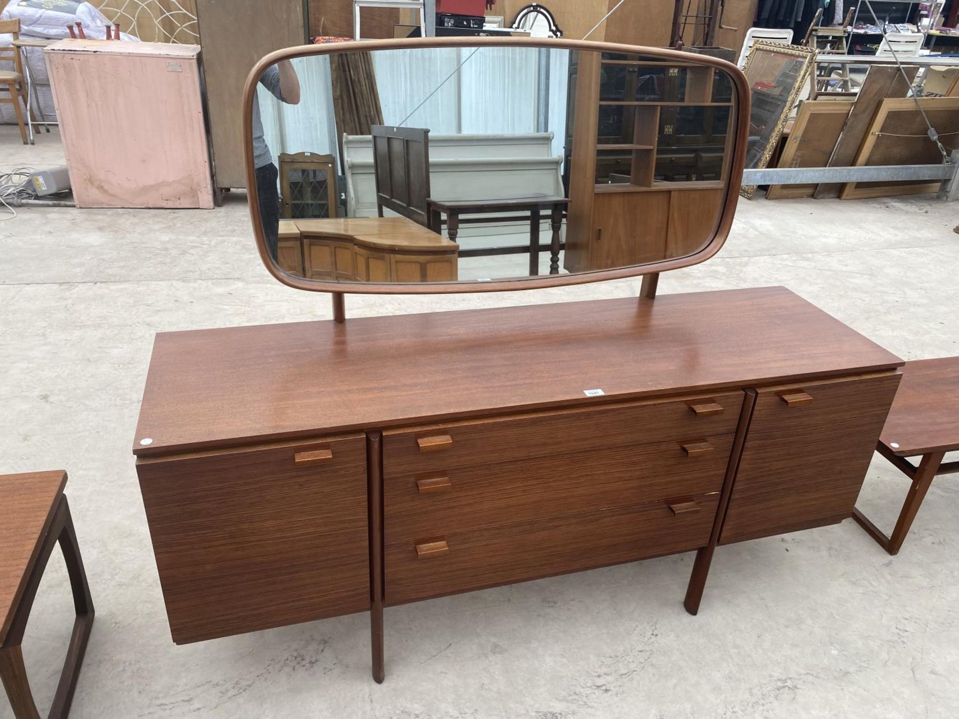A TEAK DRESSING TABLE WITH TWO DOORS, THREE DRAWERS AND UPPER MIRROR