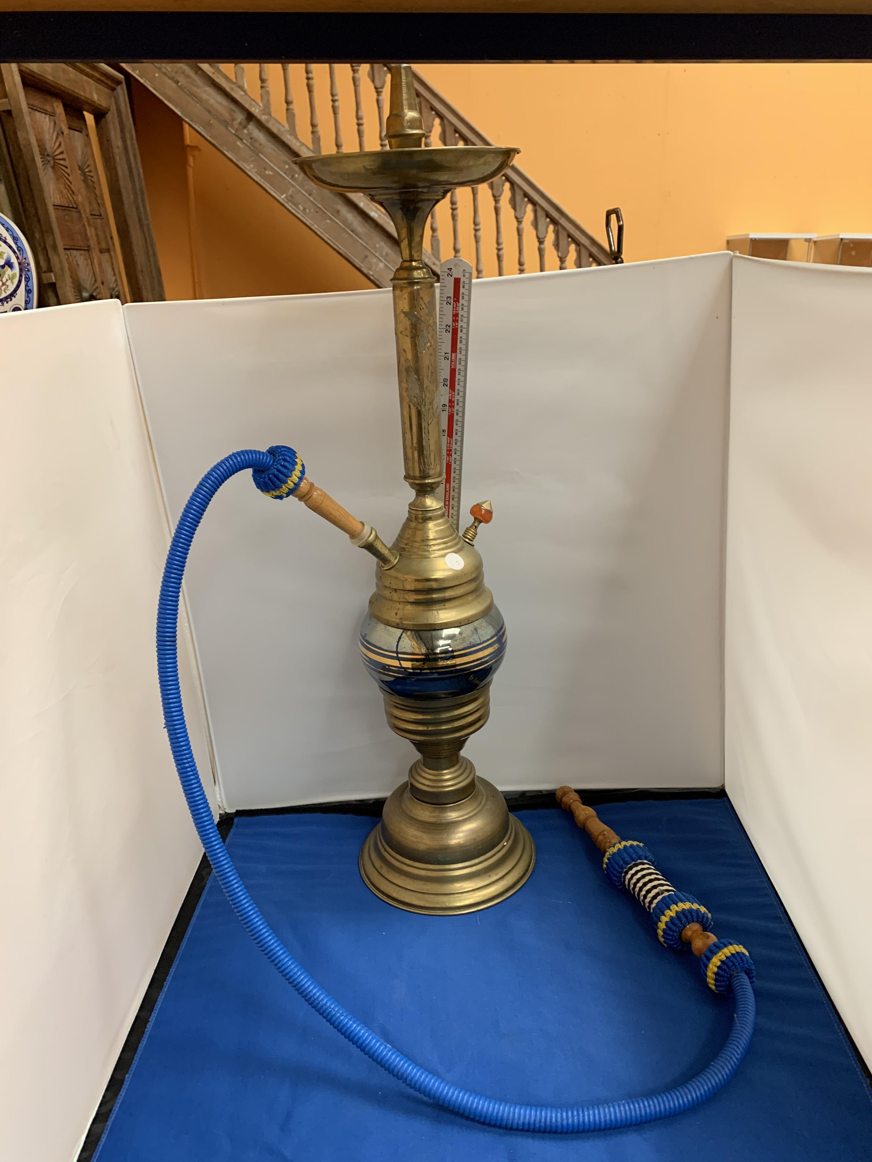 A BRASS SHISHA PIPE WITH A BLUE BRAIDED PIPE