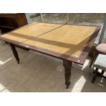 A MAHOGANY DINING TABLE WITH GOLDEN LEATHER TOP