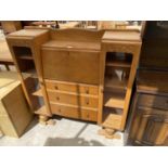 AN OAK SIDE BY SIDE CABINET WITH FALL FRONT, THREE DRAWERS AND TWO GLAZED DOORS