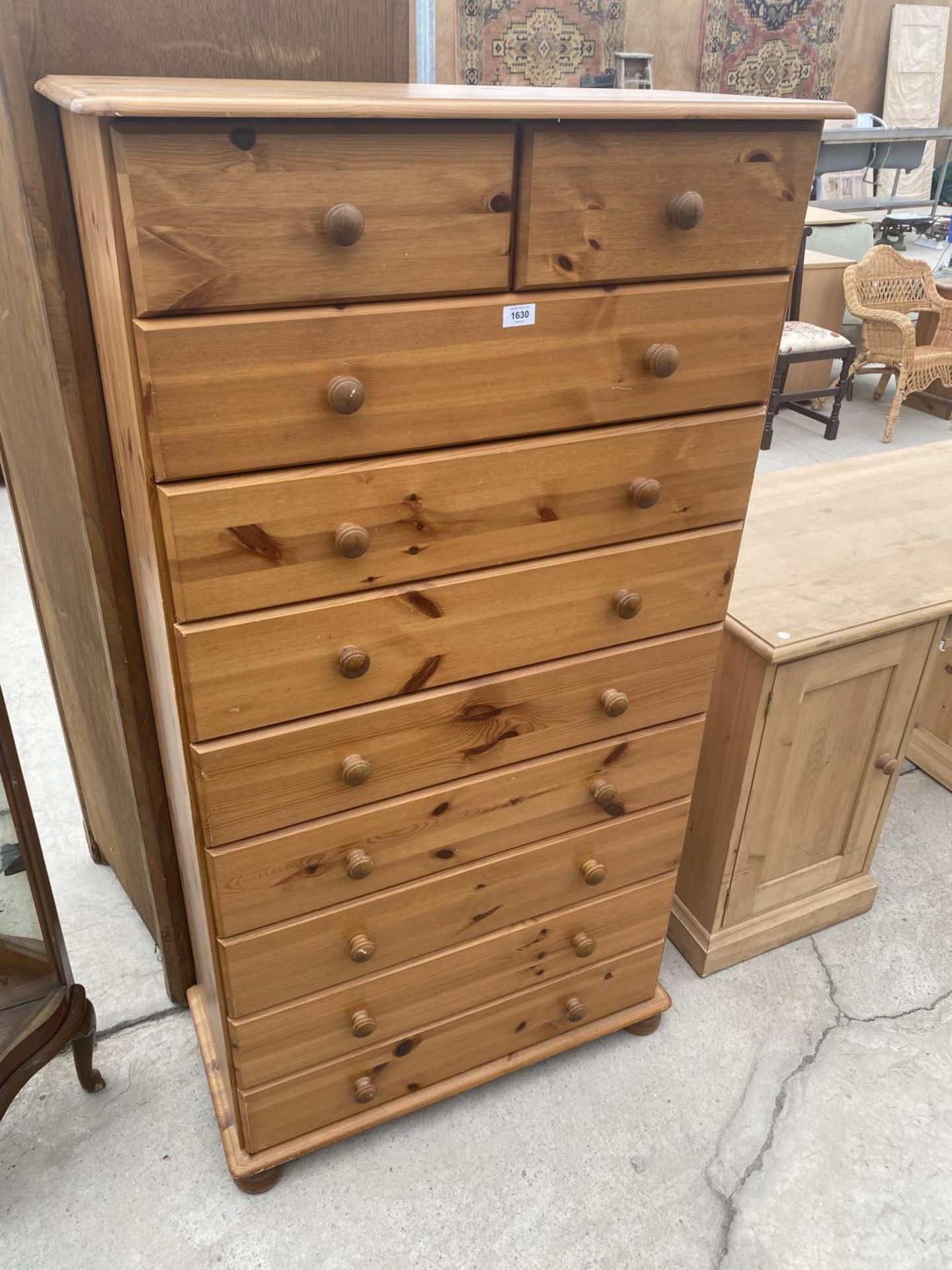 A TALL PINE CHEST OF TWO SHORT AND EIGHT LONG DRAWERS