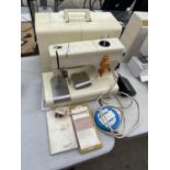 A CASED FRISTER ROSSMANN SEWING MACHINE WITH ACCESSORIES IN WORKING ORDER