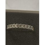 AN 18 CARAT GOLD RING SET WITH 9 IN LINE DIAMONDS - 0.33 CARAT - RING SIZE N