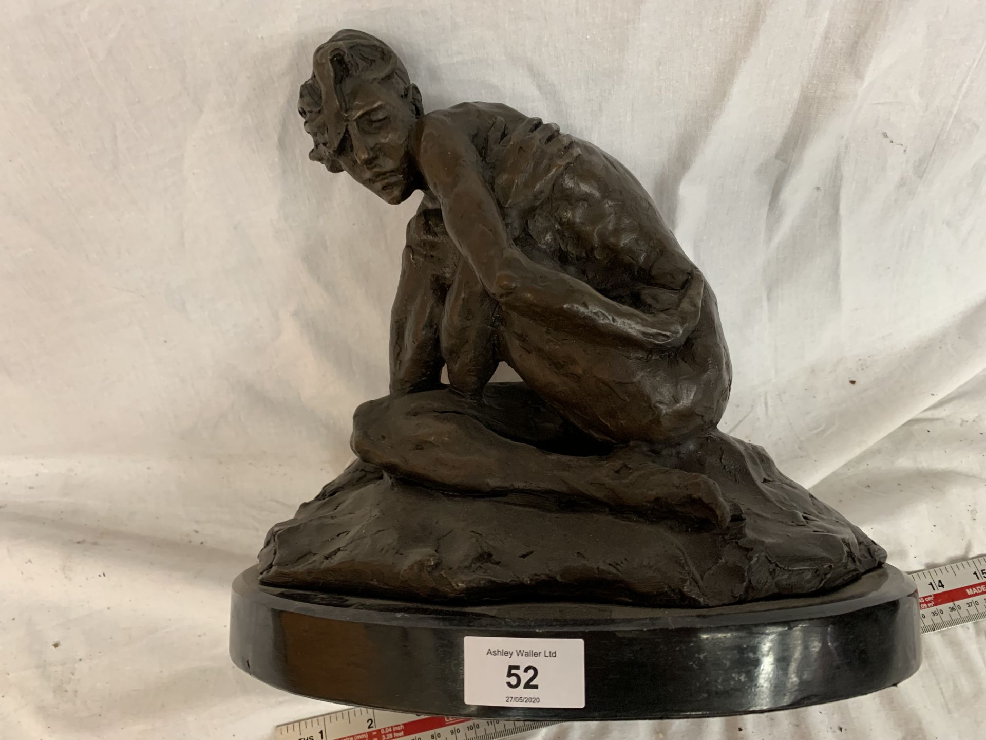 A BRONZE DISCREETLY NUDE FIGURE ON A MARBLE BASE