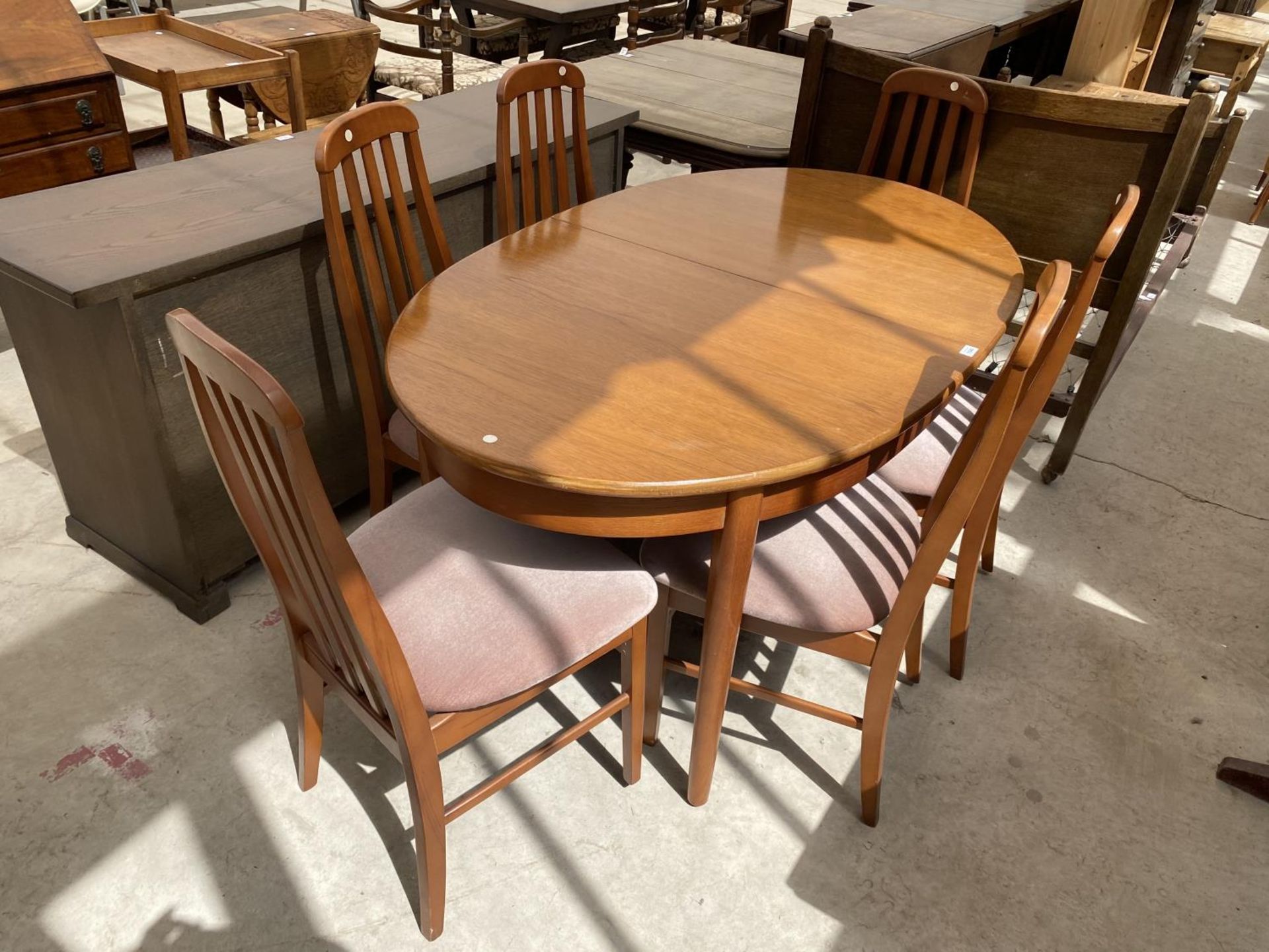 A RETRO EXTENDING TEAK DINING TABLE AND SIX TEAK DINING CHAIRS