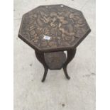 AN OCTAGONAL MAHOGANY SIDE TABLE WITH HEAVILY CARVED TOP, LOWER SHELF AND SUPPORTS