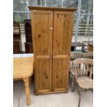 A PINE WARDROBE WITH TWO DOORS