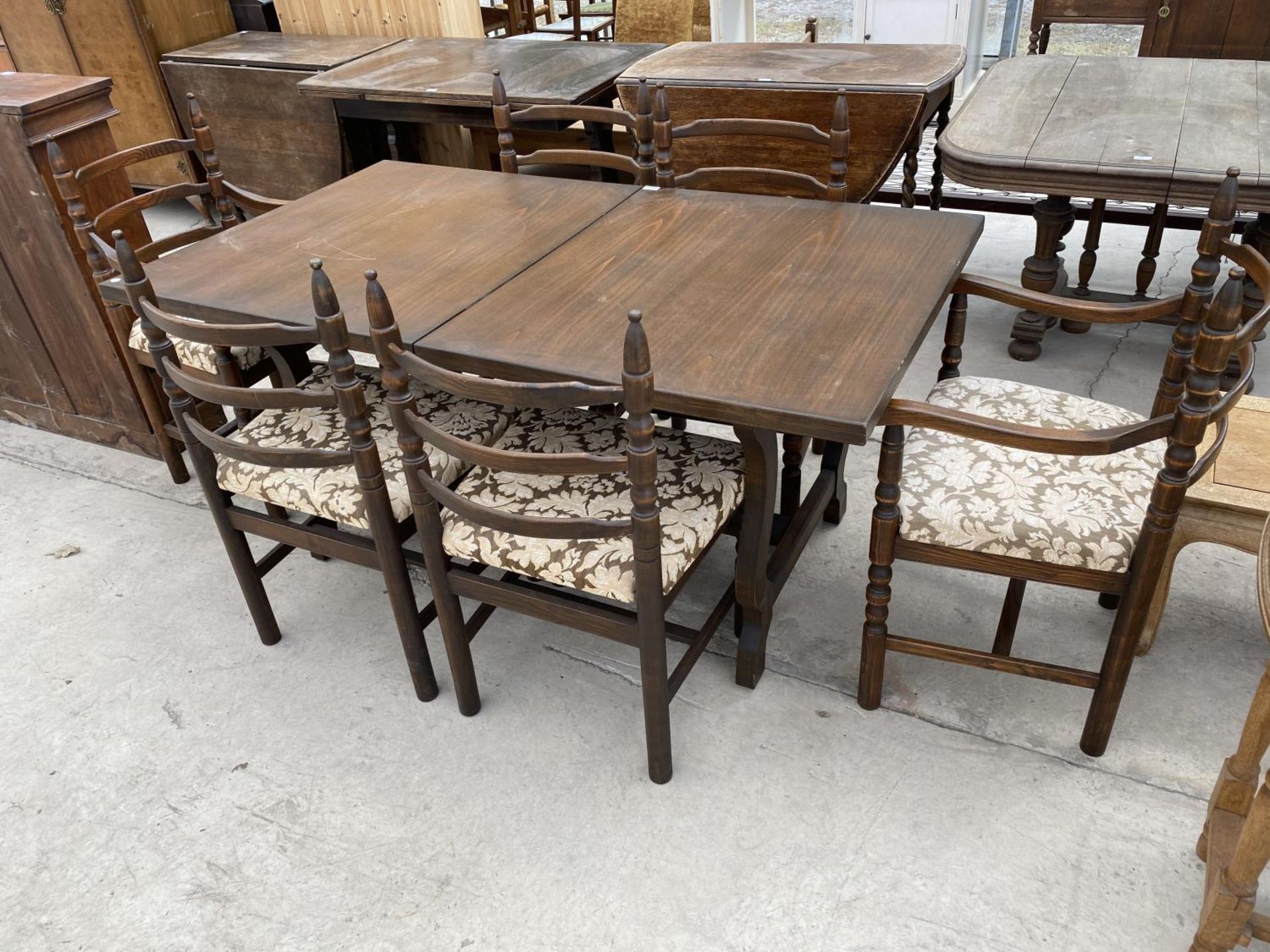 A YOUNGER TOLEDO OAK EXTENDING DINING TABLE WITH FOUR DINING CHAIRS AND TWO CARVERS