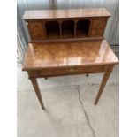 A LADIES WALNUT DESK ON TAPERED SUPPORTS WITH LOWER DRAWER AND FOUR SMALL UPPER DRAWERS