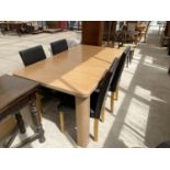 A MODERN DINING TABLE AND FOUR HIGH BACK DINING CHAIRS