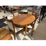 AN EXTENDING OVAL TEAK DINING TABLE AND FOUR DINING CHAIRS