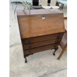 A MAHOGANY BUREAU ON CABRIOLE SUPPORTS WITH FALL FRONT AND THREE DRAWERS
