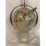 A SMALL GLOBE ON A WOODEN BASE APPROXIMATELY 9.5 INCHES HIGH