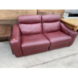 A RED LEATHER TWO SEATER SOFA