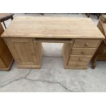 A PINE DESK WITH ONE DOOR AND FOUR DRAWERS