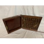 A VINTAGE WOODEN KEY BOX WITH KEYS