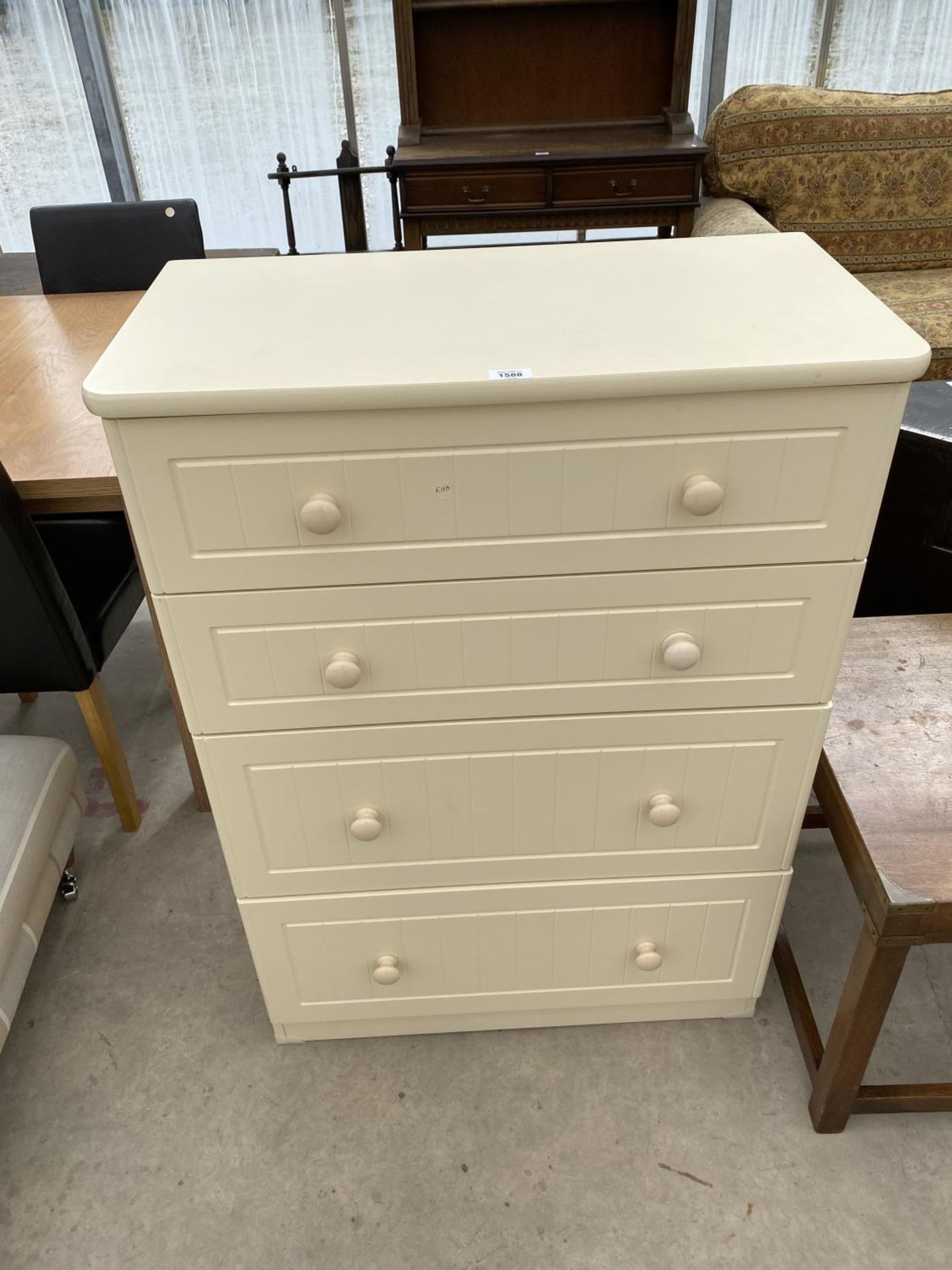 A CREAM CHEST OF FOUR DRAWERS