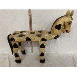 A WOODEN STOOL IN THE FORM OF A HORSE PAINTED IN THE STYLE OF AN APPALOOSA