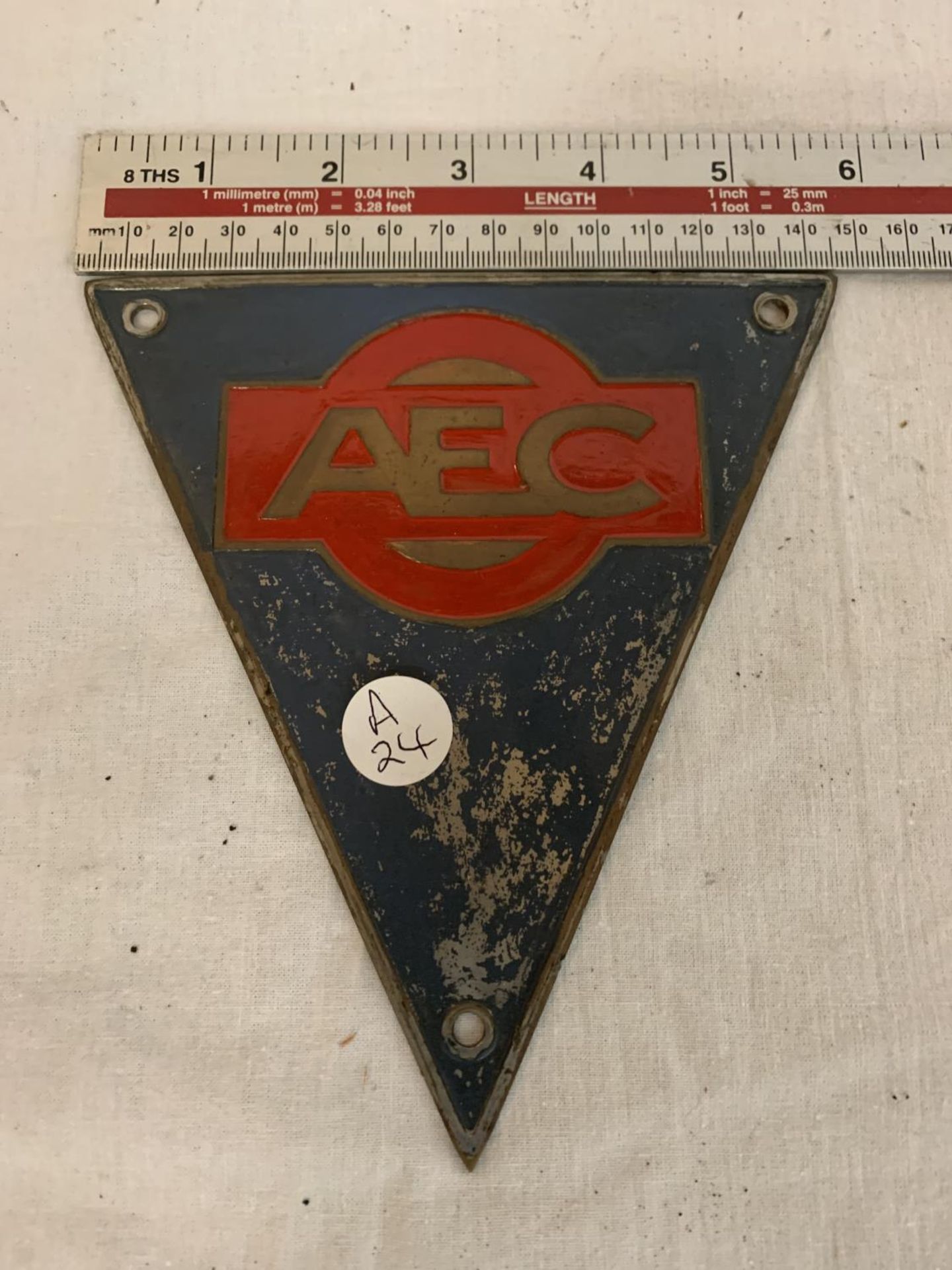 A VINTAGE CAST TRAINGULAR AEC SIGN 15CM ACROSS THE TOP