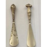 TWO SHOEHORNS WITH HALLMARKED BIRMINGHAM SILVER HANDLES 1904 AND 1911