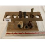 A VINTAGE WOODEN SMOKERS PIPE RACK WITH THREE PIPES
