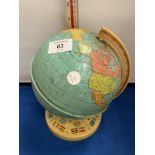 A VINTAGE TIN GLOBE 8 INCHES HIGH WITH A STAND DISPLAYING FLAGS OF THE WORLD
