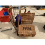 A WICKER BASKET AND A STICK STAND WITH THREE STICKS