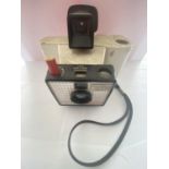 A VINTAGE POLAROID CAMERA