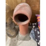 A LARGE RED COLOURED CHIMNEY POT