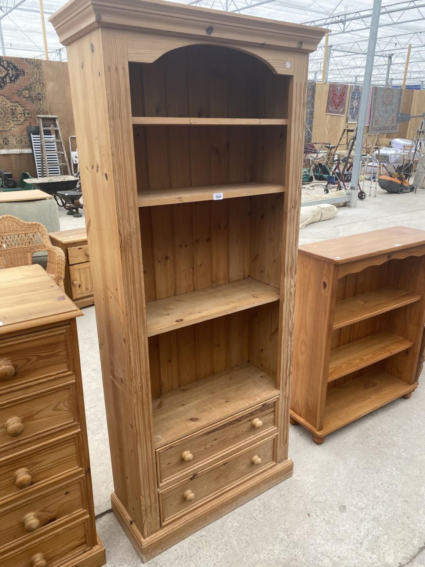 A TALL PINE FOUR TIER BOOKSHELF WITH TWO LOWER DRAWERS