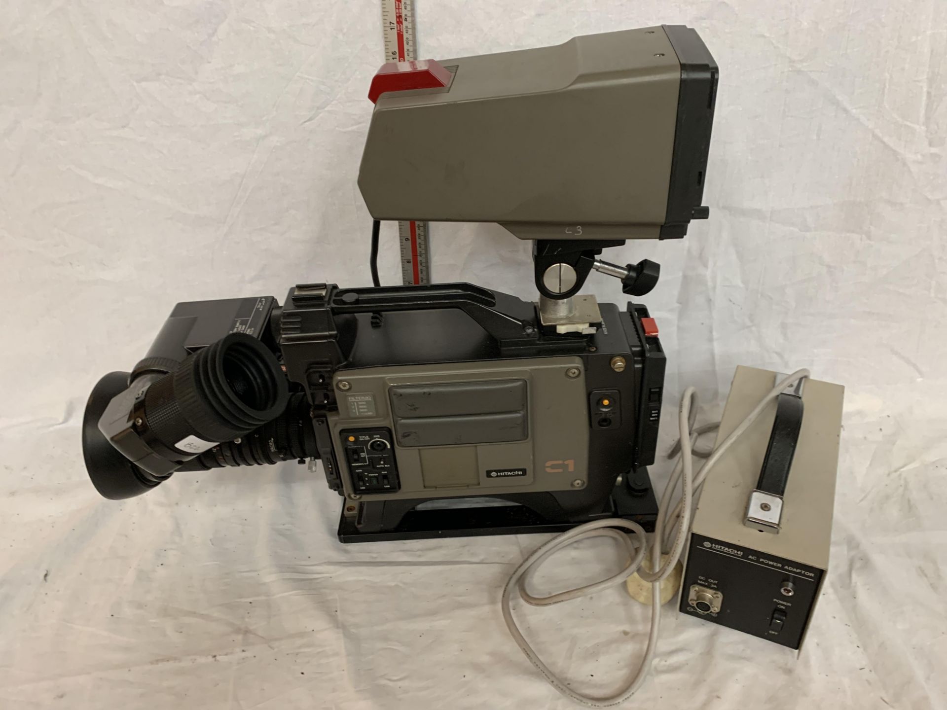 A HITACHI C1 BROADCAST CAMERA WITH ATTACHED SCREEN AND POWER PACK