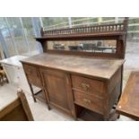 AN OAK SIDEBOARD WITH ONE DOOR, FOUR DRAWERS AND GALLERIED UPPER SHELF