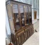A LARGE SOLID OAK CABINET WITH THREE LOWER DOORS AND DRAWERS AND FOUR UPPER GLAZED DOORS